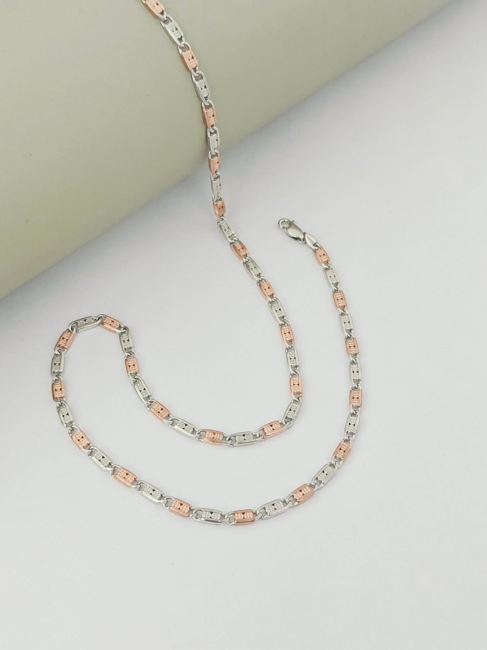 Two silver chains with pink accents on a light gray background